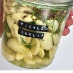 A jar with pickled garlic cloves