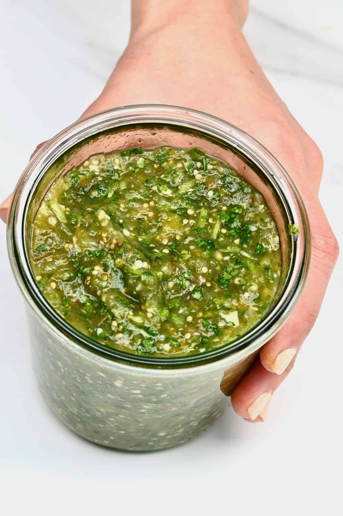 A jar with tomatillo green chili salsa