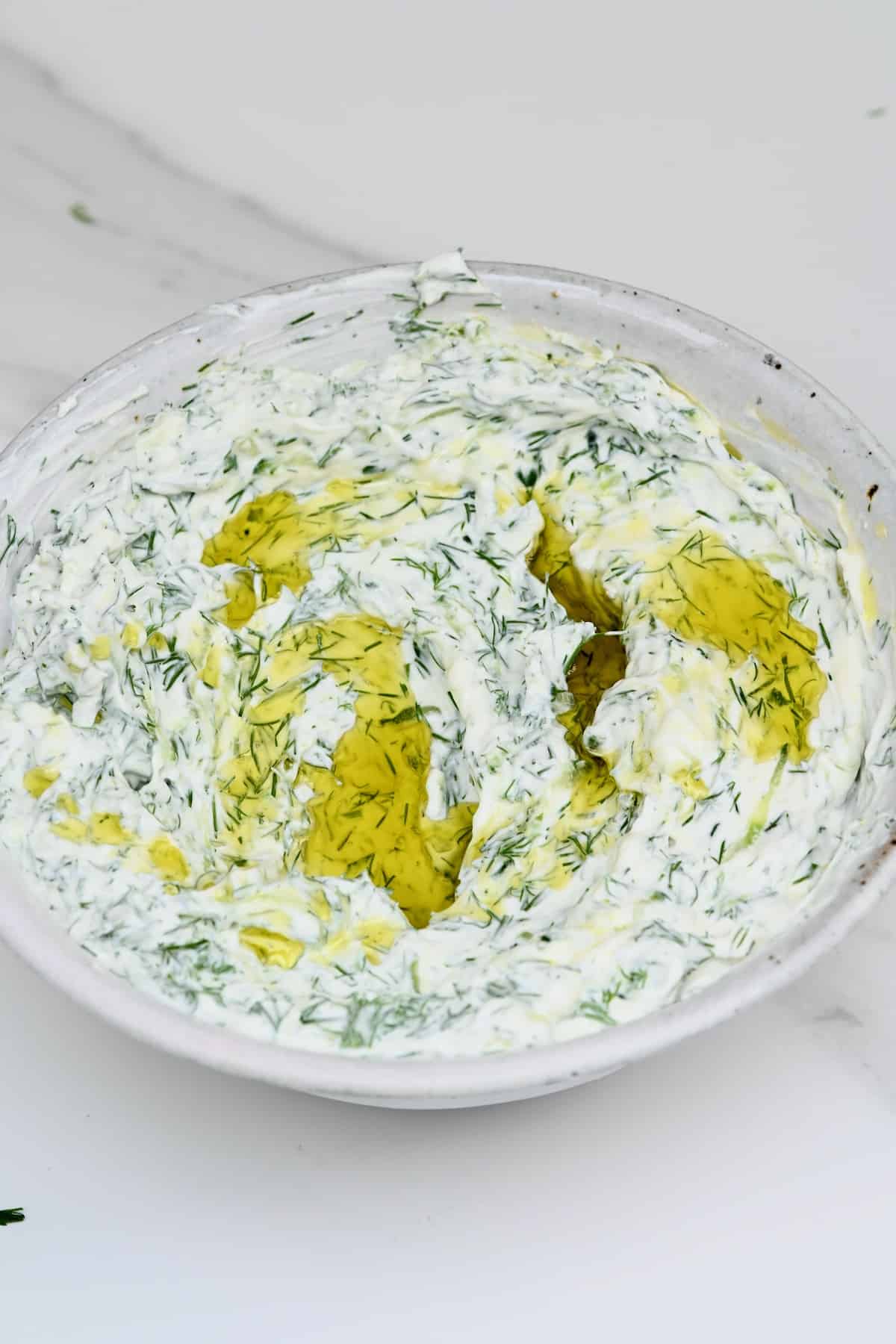 Tzatziki (gyro sauce) in a bowl topped with olive oil