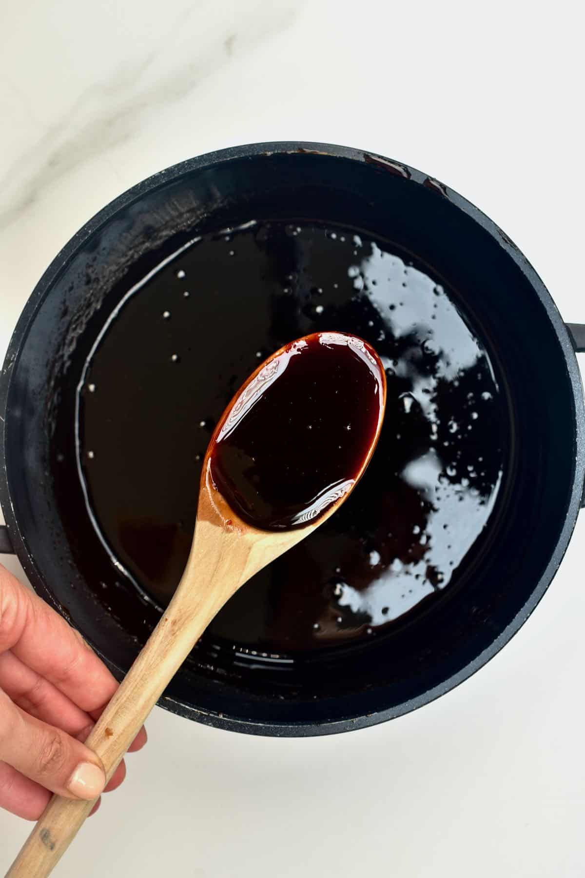 A spoonful of date syrup over a pan