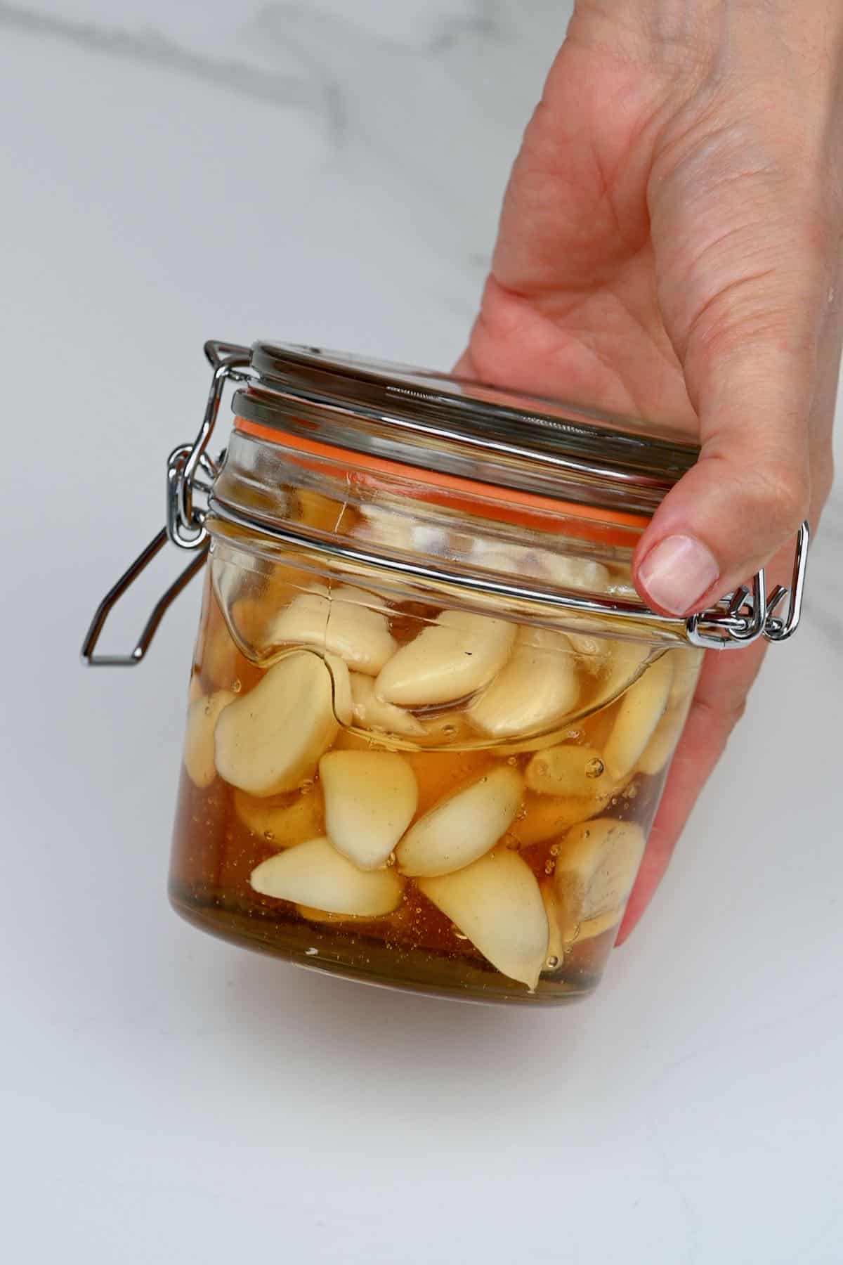 A jar with fermented honey garlic