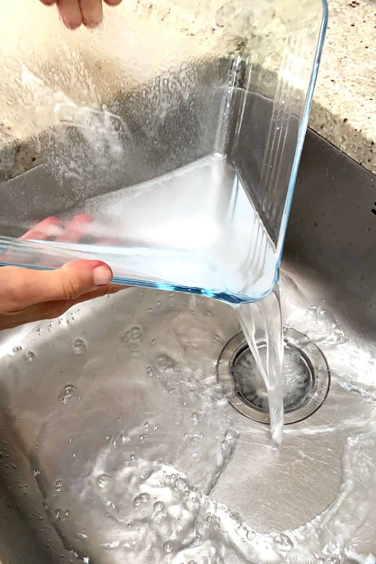 Pouring salted water in a sink