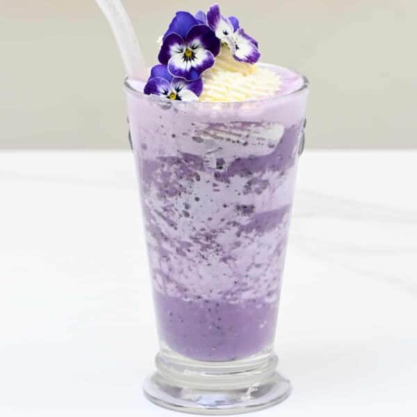 Blueberry Milkshake with edible flowers decoration