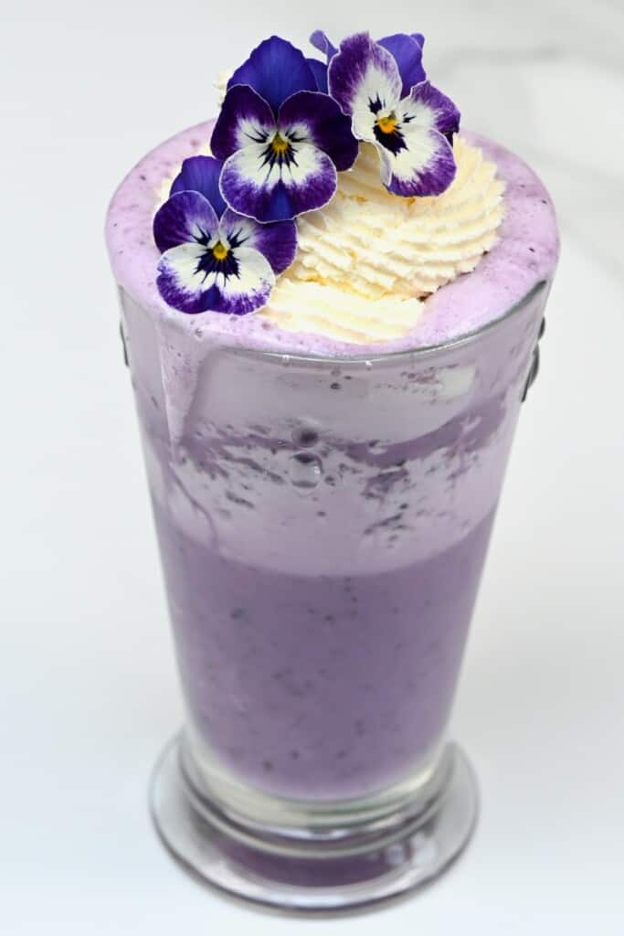 Blueberry ube frappuccino decorated with edible flowers