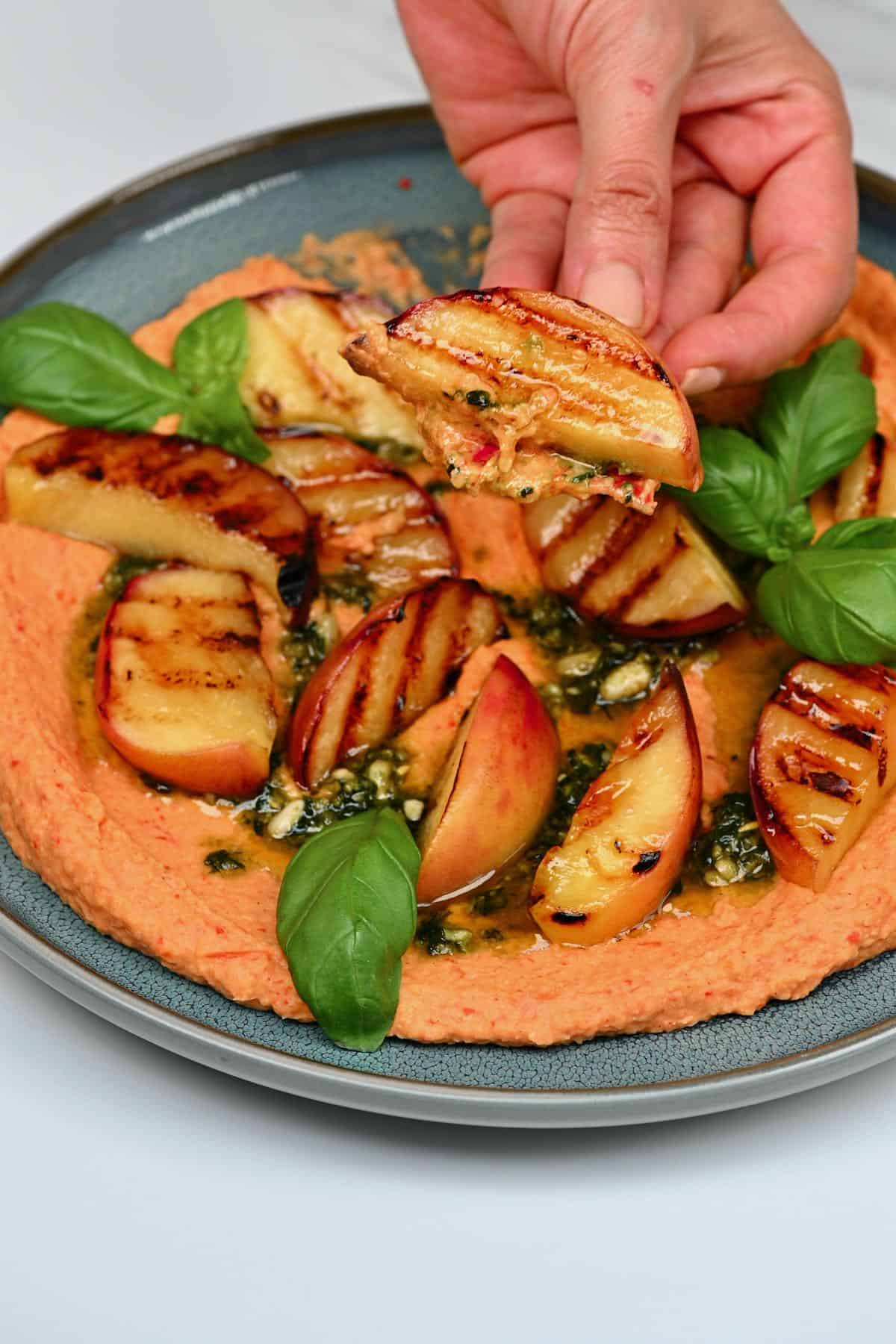 Grilled peach with roasted red pepper hummus