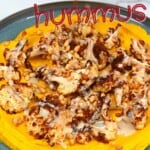 Golden turmeric hummus topped with cauliflower and pine nuts