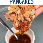 Korean vegetable pancake dipped in sauce