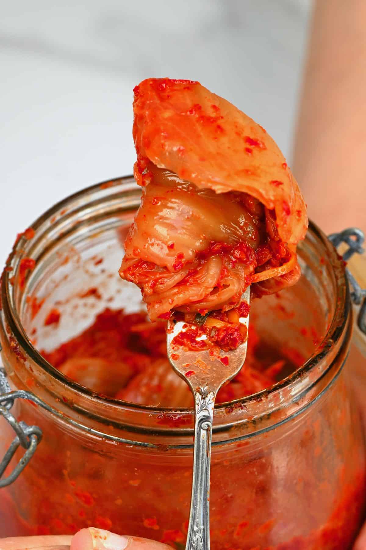 Scooping out kimchi from a jar