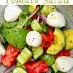 Avocado cucumber tomato salad in a bowl with some mozzarella balls