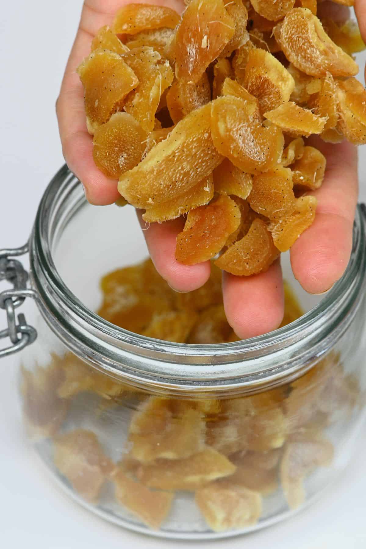 Placing crystallized ginger in a jar