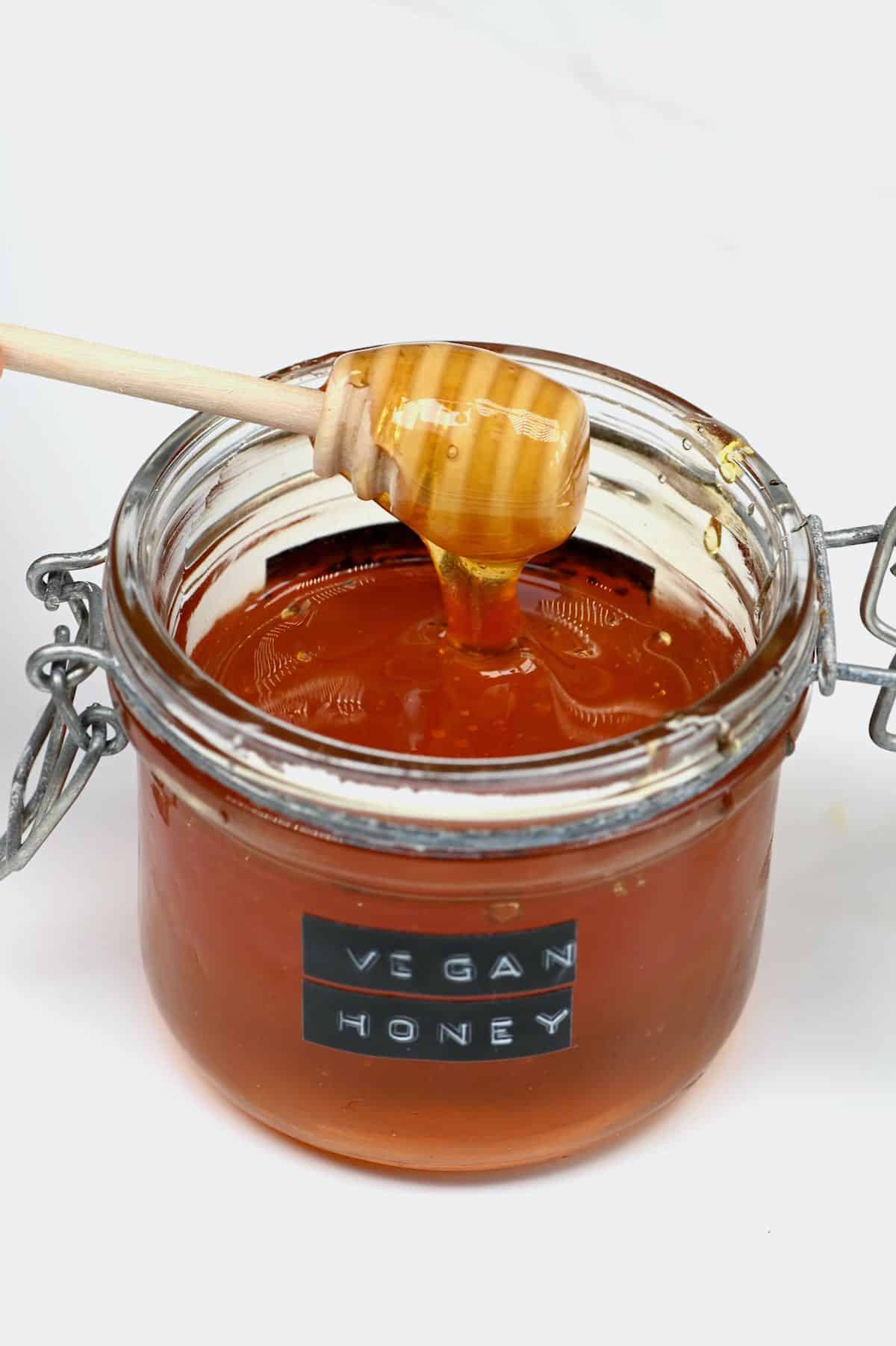 Vegan honey dripping in a jar