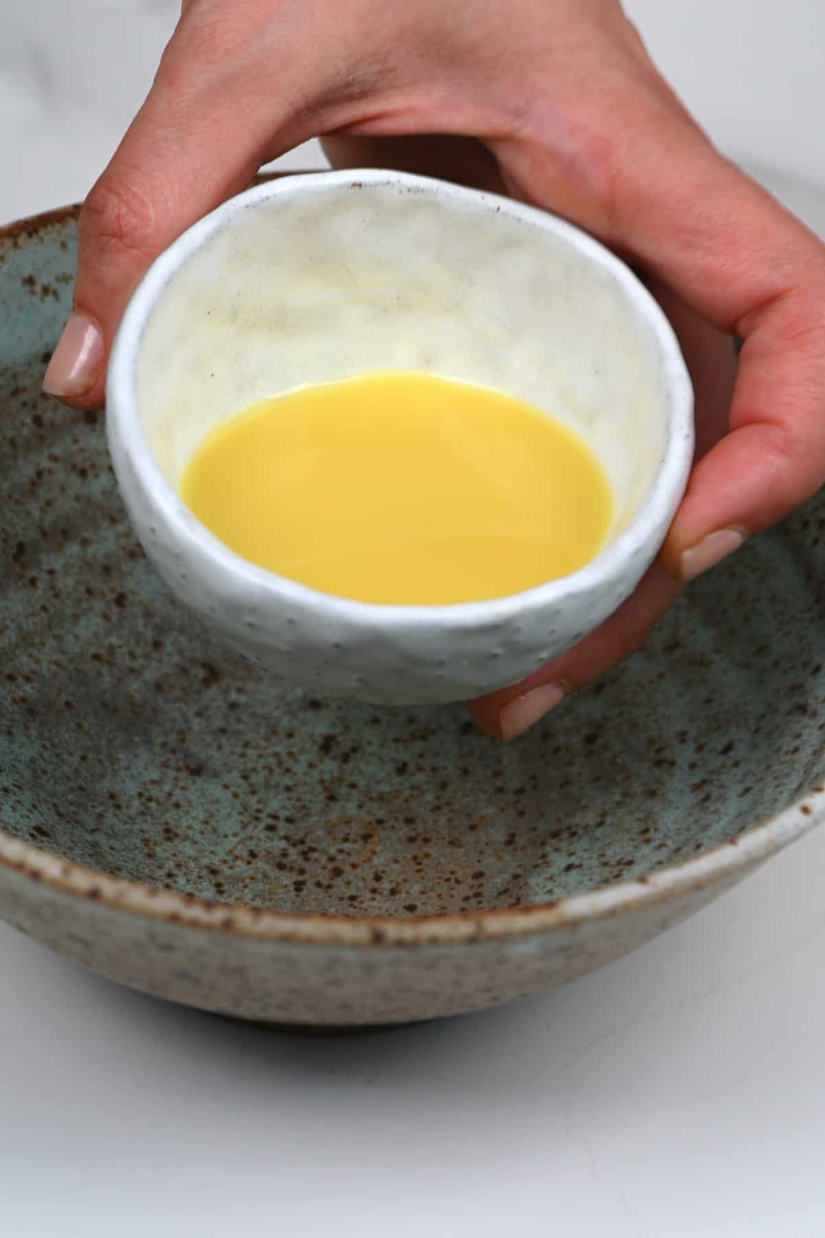 Pouring ginger juice in a bowl