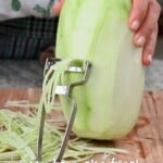 Shredding a green papaya for a salad