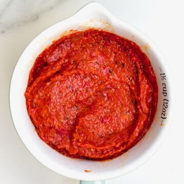 Harissa sauce in a measuring cup