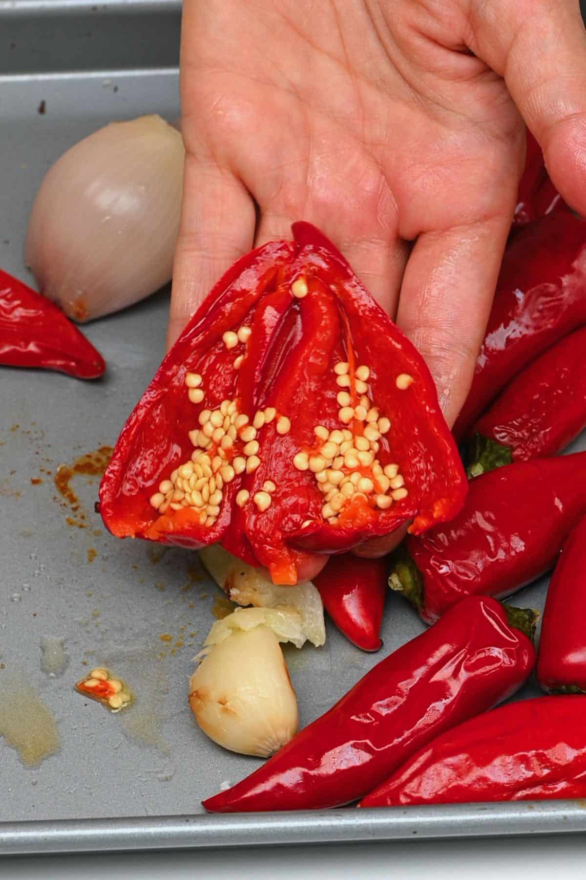 Removing seeds from roasted chilies