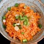 Kimchi rice topped with green onion in a bowl
