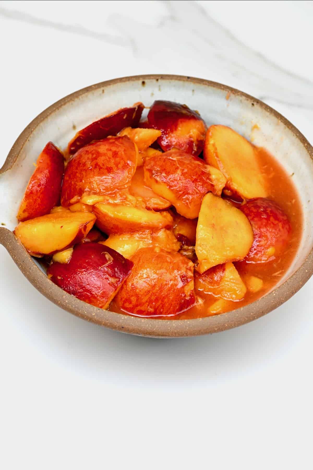 Cooked peaches in a bowl