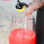 Juicing a tomato with a juicer