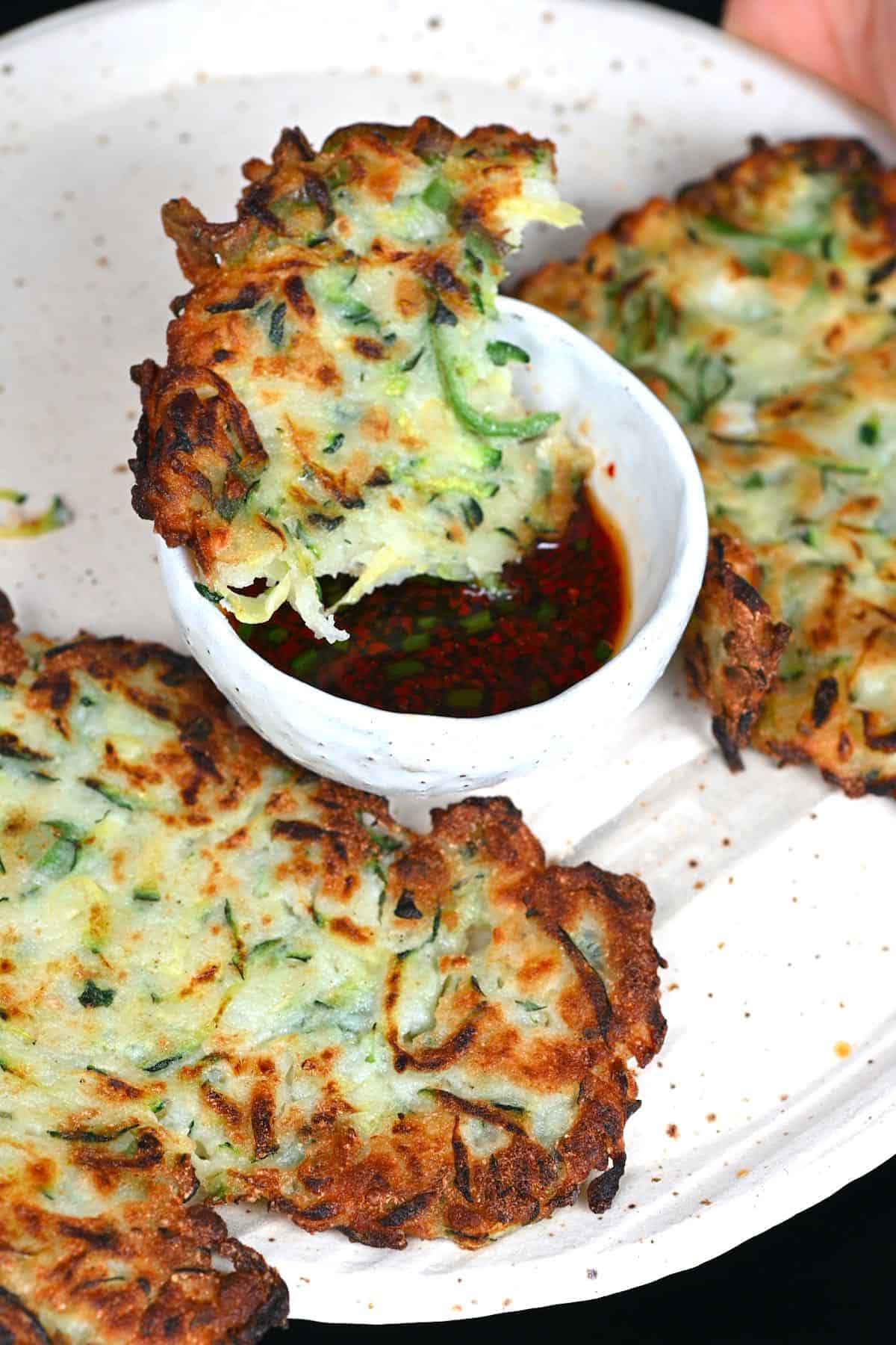 Zucchini fritters dipped in sauce