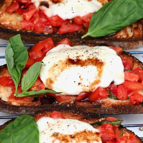 Mozzarella and tomato bruschetta with basil leaves