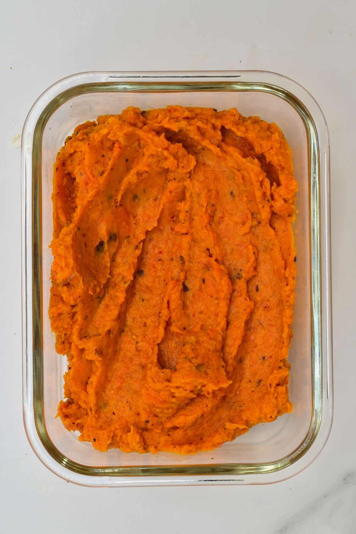 Roasted carrot dip in a glass container