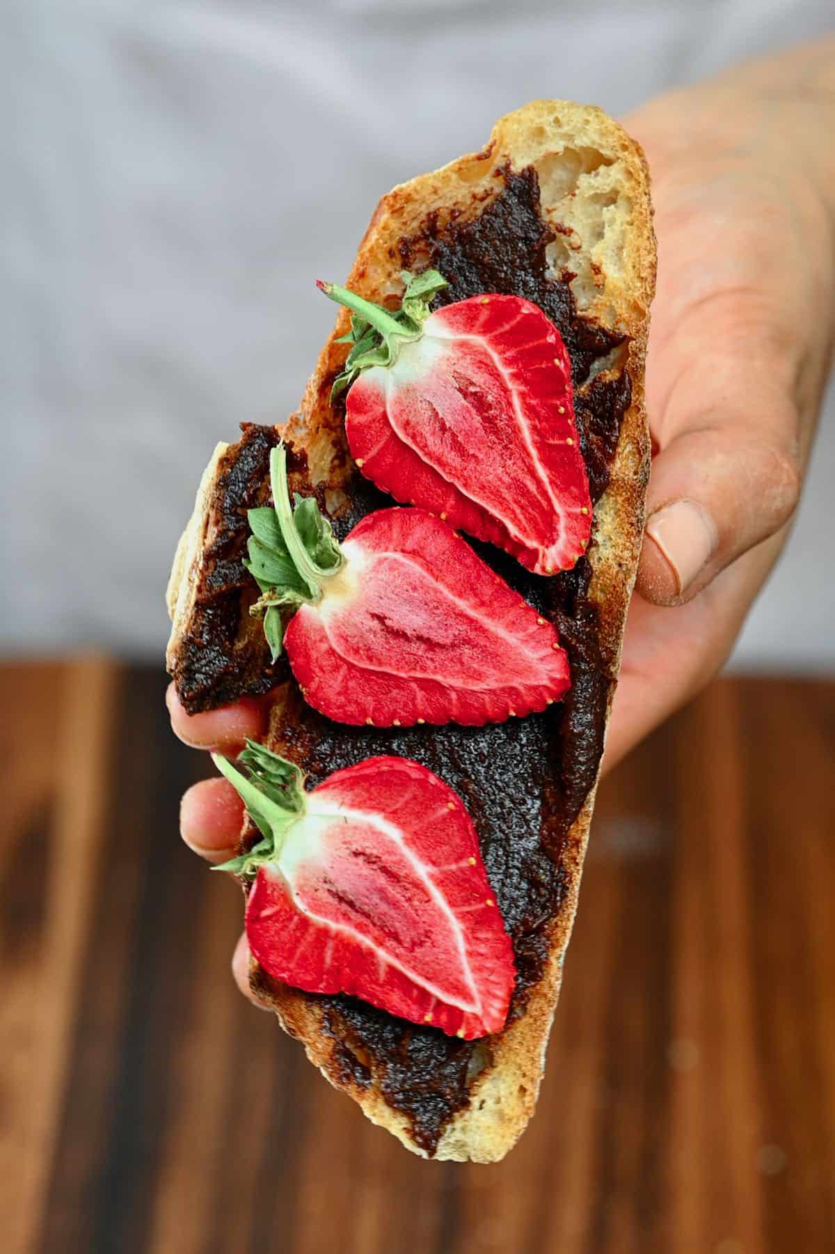 Brownie batter dip spread on toast topped with strawberries