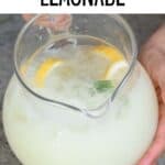 A glass pitcher with creamy lemonade