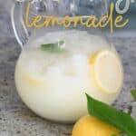 A pitcher with creamy lemonade and a lemon