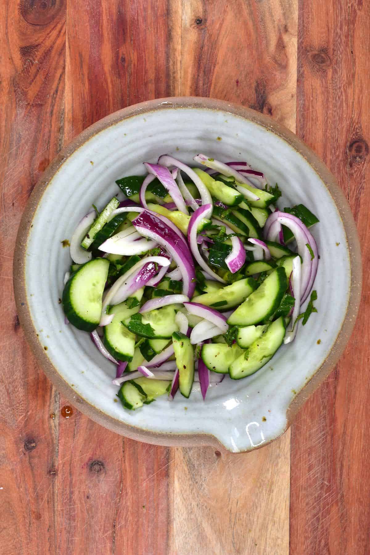 A bowl with cucumber onion salad