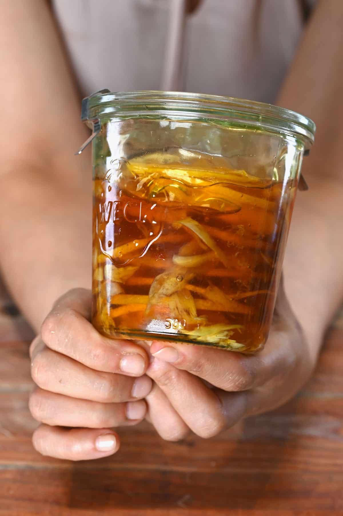Holding a jar with honey ferment