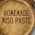 Homemade miso paste in a large container