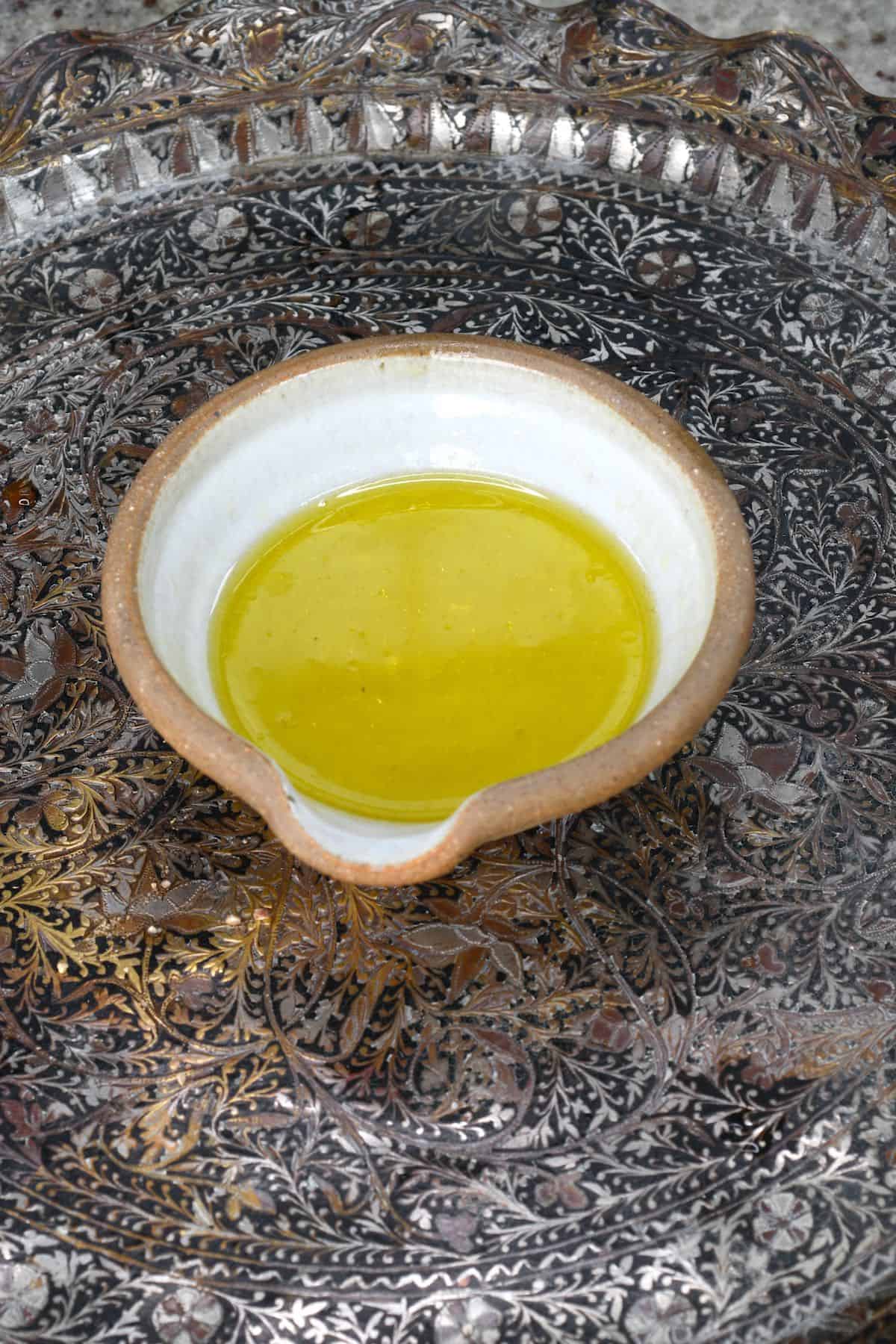 A bowl with salad dressing