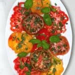 Simple tomato salad topped with basil in a plate - 20