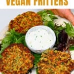 Three vegan fritters and yogurt over salad in a plate