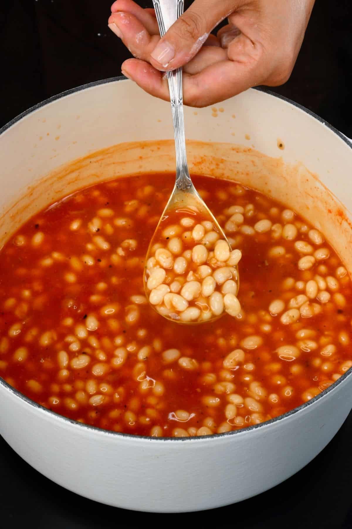 A ladle with homemade baked beans