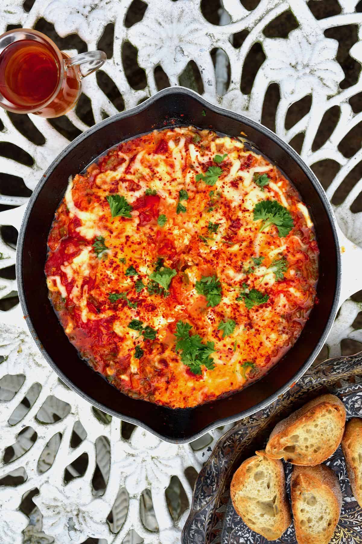 Menemen in a pan with bread and tea
