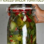 A jar with pickled green tomatoes