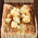 Roasted garlic cloves on top of toasted bread