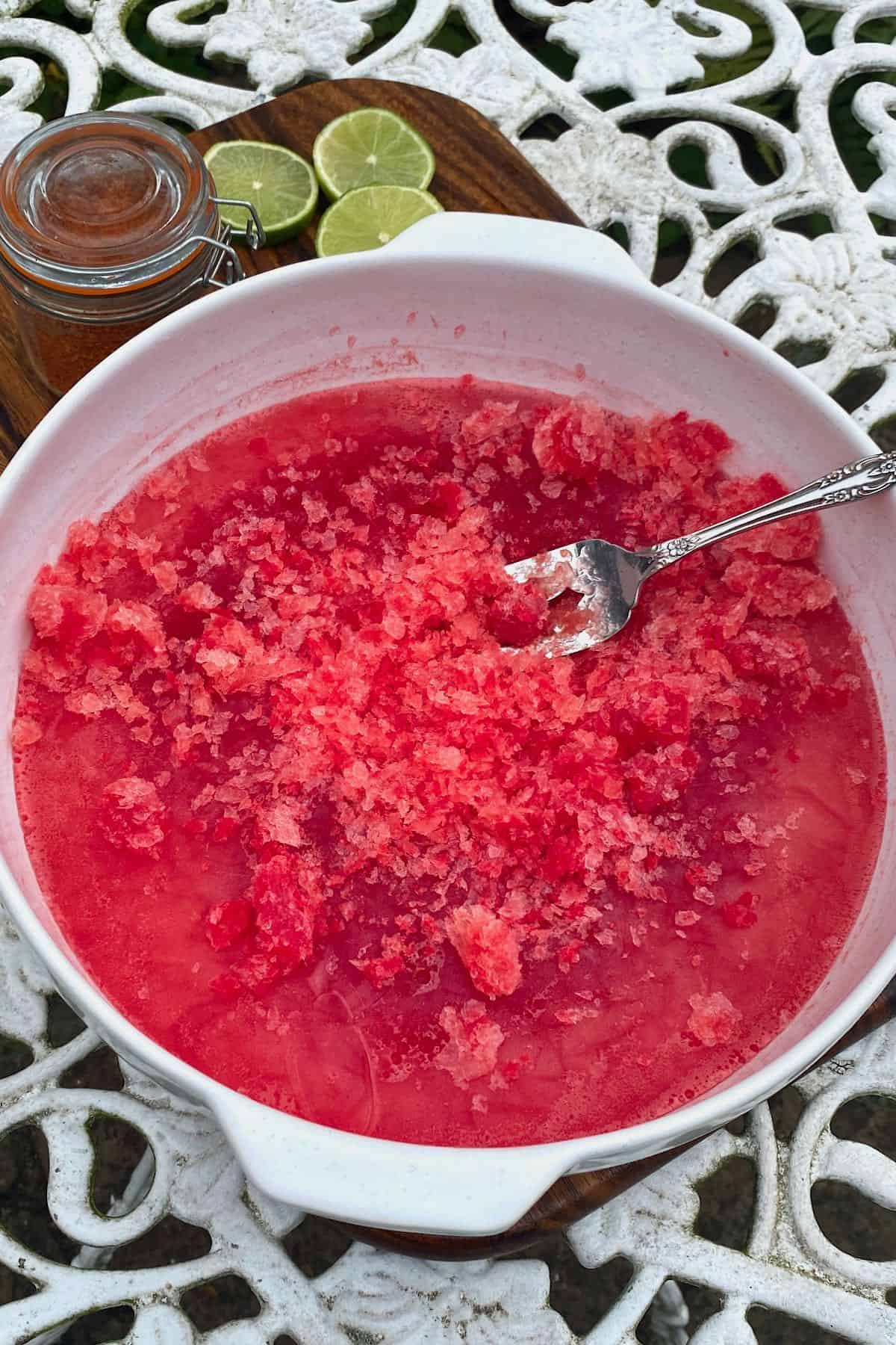 Crushing frozen watermelon with a fork