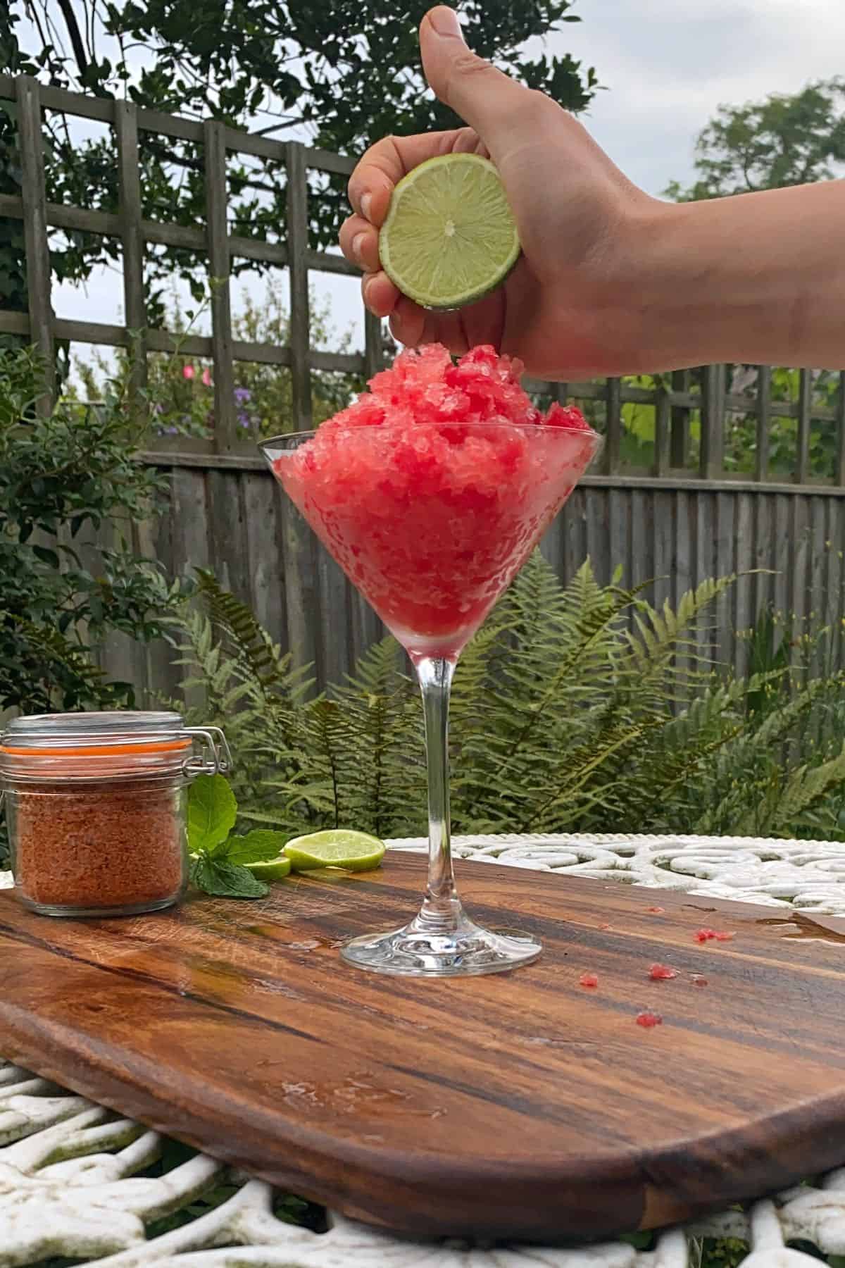 Topping watermelon slush with lime