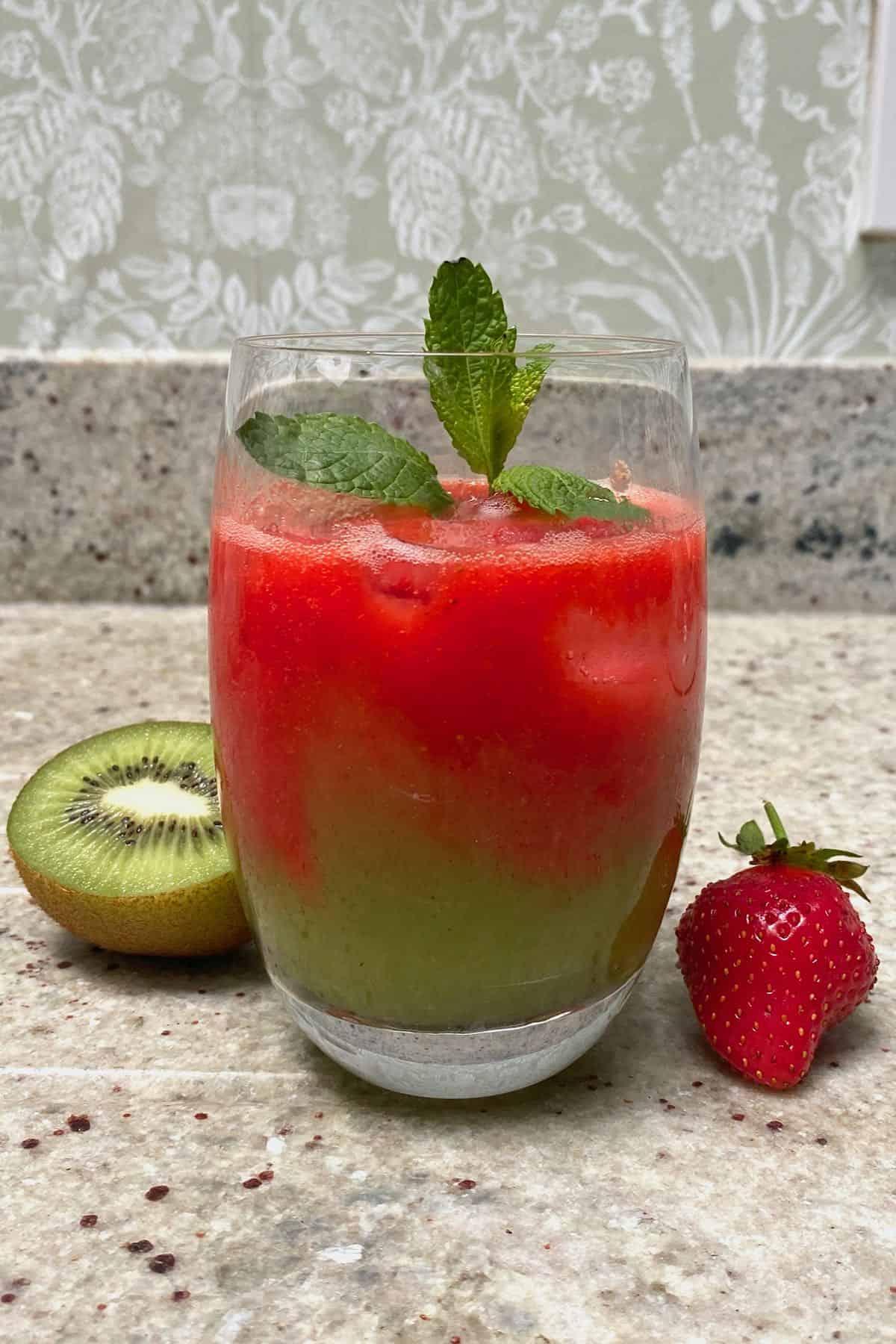 A glass with strawberry kiwi juice