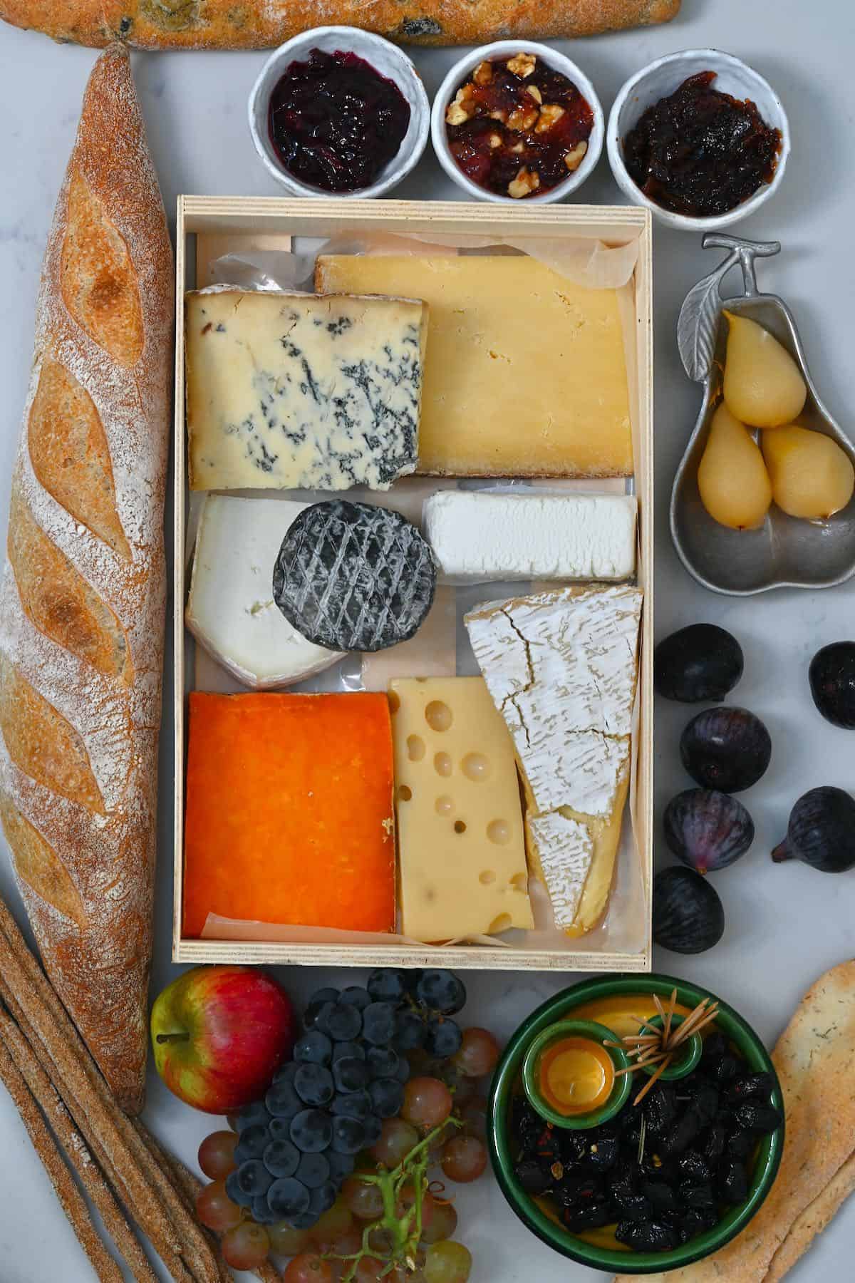 Cheese board with bread jams and fruit