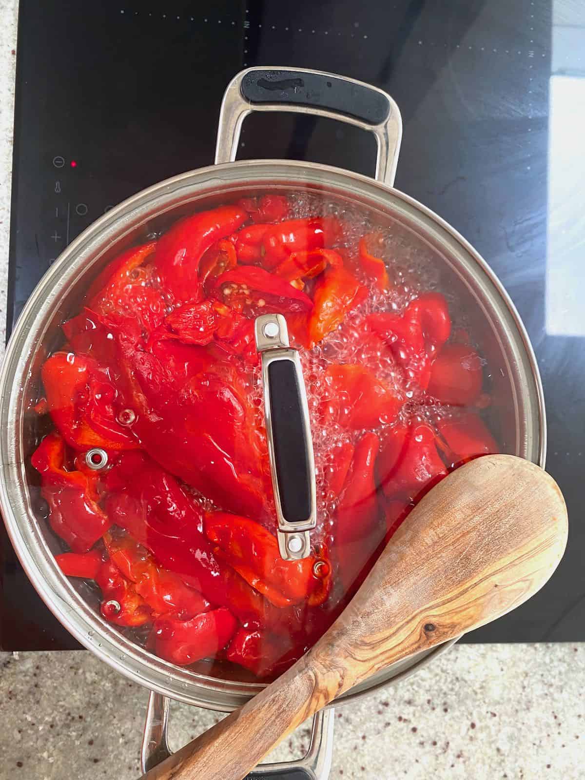 Cooking red peppers in a pot
