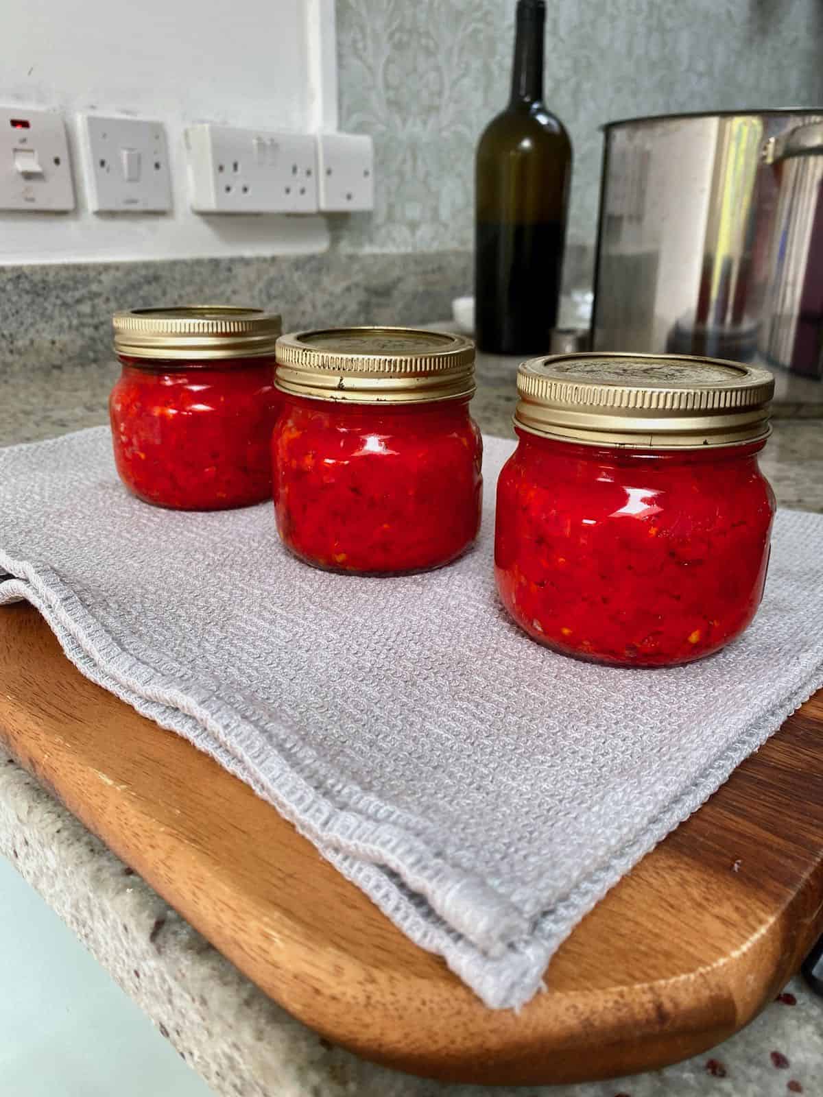 Three home-canned jars with red paste