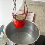 Holding a home-canned jar with tongs