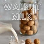 Pouring homemade walnut milk into a glass