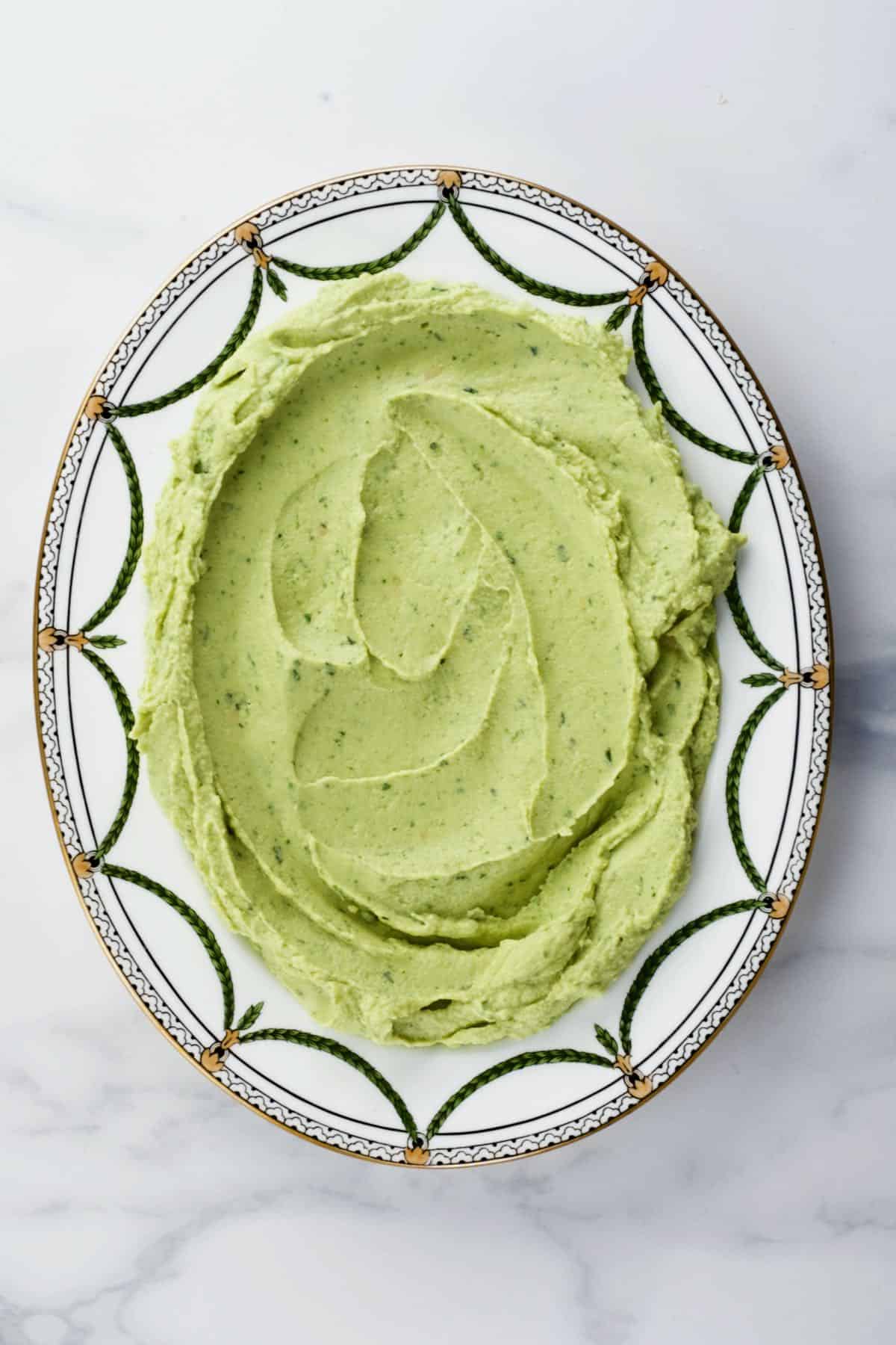 A plate with basil hummus