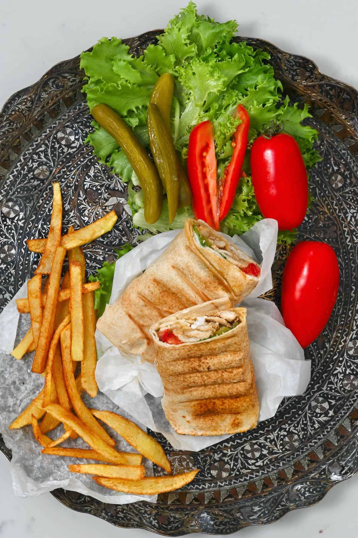 Chicken shawarma wrap cut in two on a platter