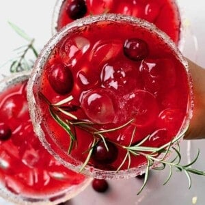 Cranberry juice served in a glass with rosemary