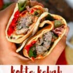 A wrap with kofta skewers and dips
